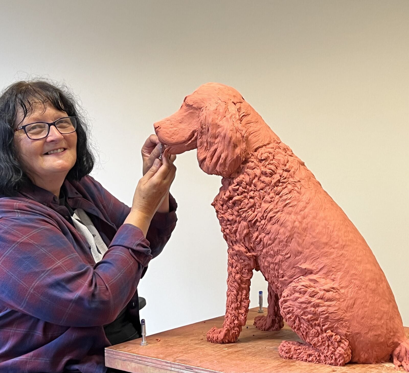 Sculptress Joel Work on Portrait Sculpture of Dog