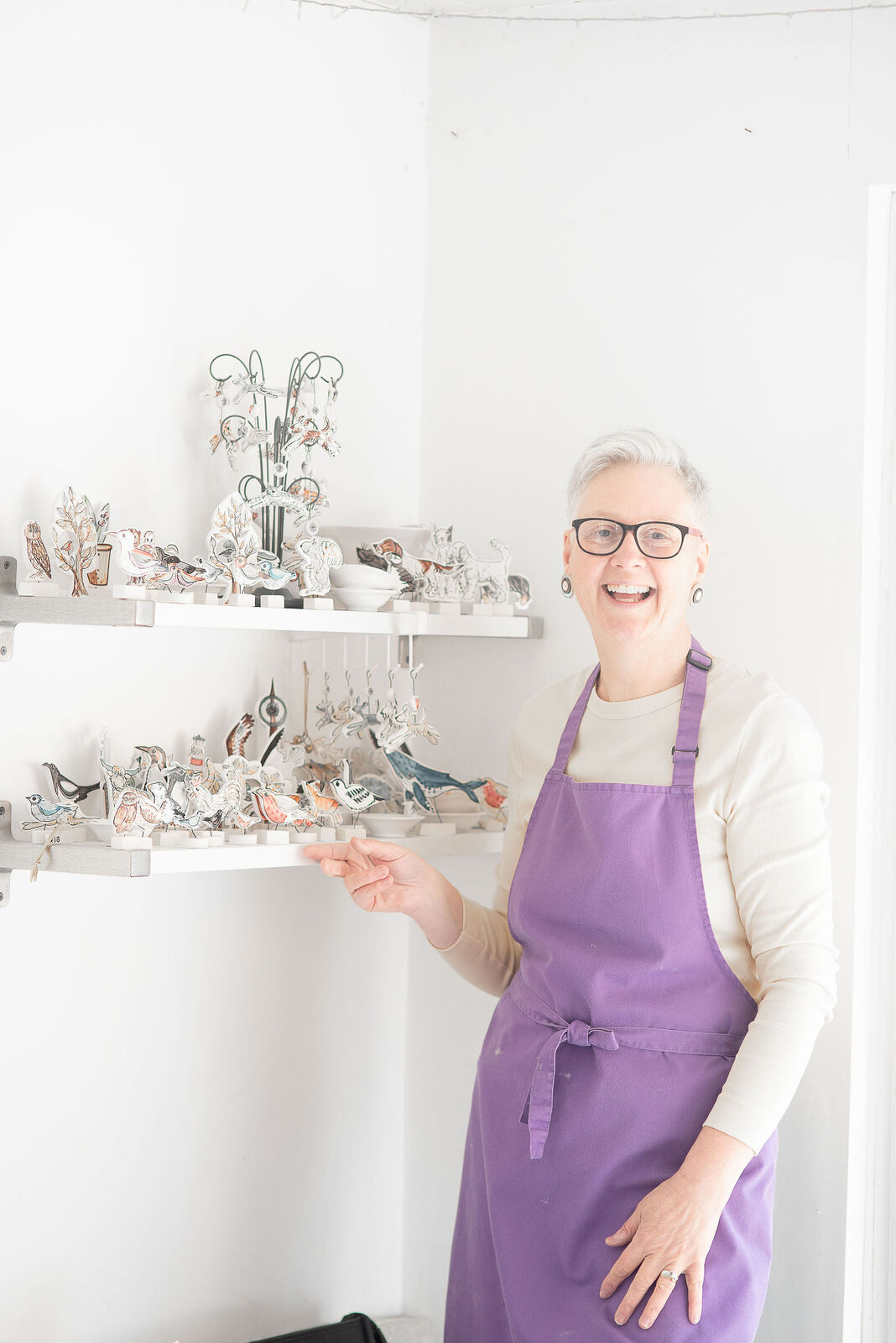 Louise with her illustrated ceramic pieces