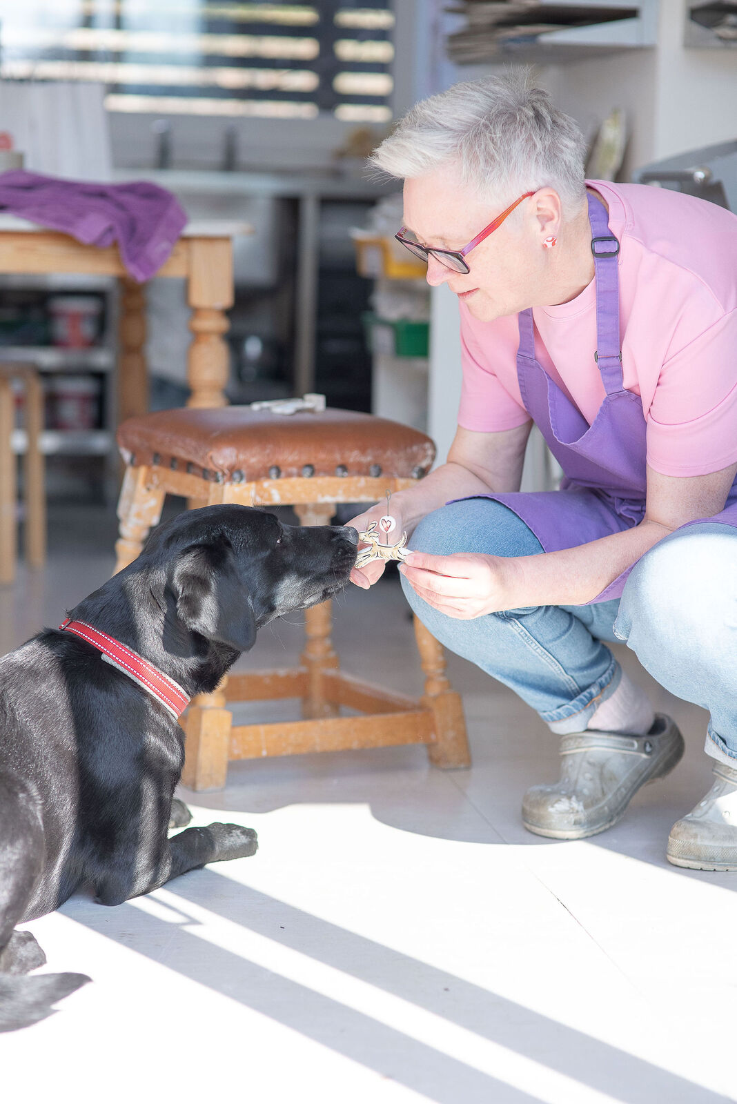 Louise with Rosie the dog in her Pottery