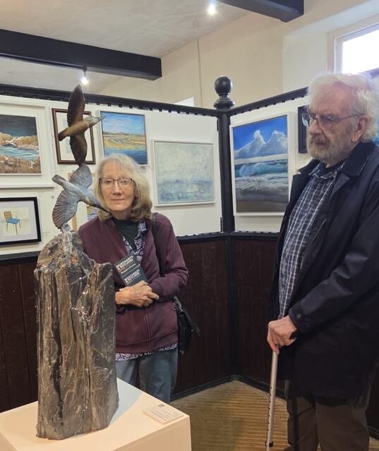visitors take a look at Kingfisher Waterfall by Sculptress JOEL at Lamport Hall central Exhibition Untitled