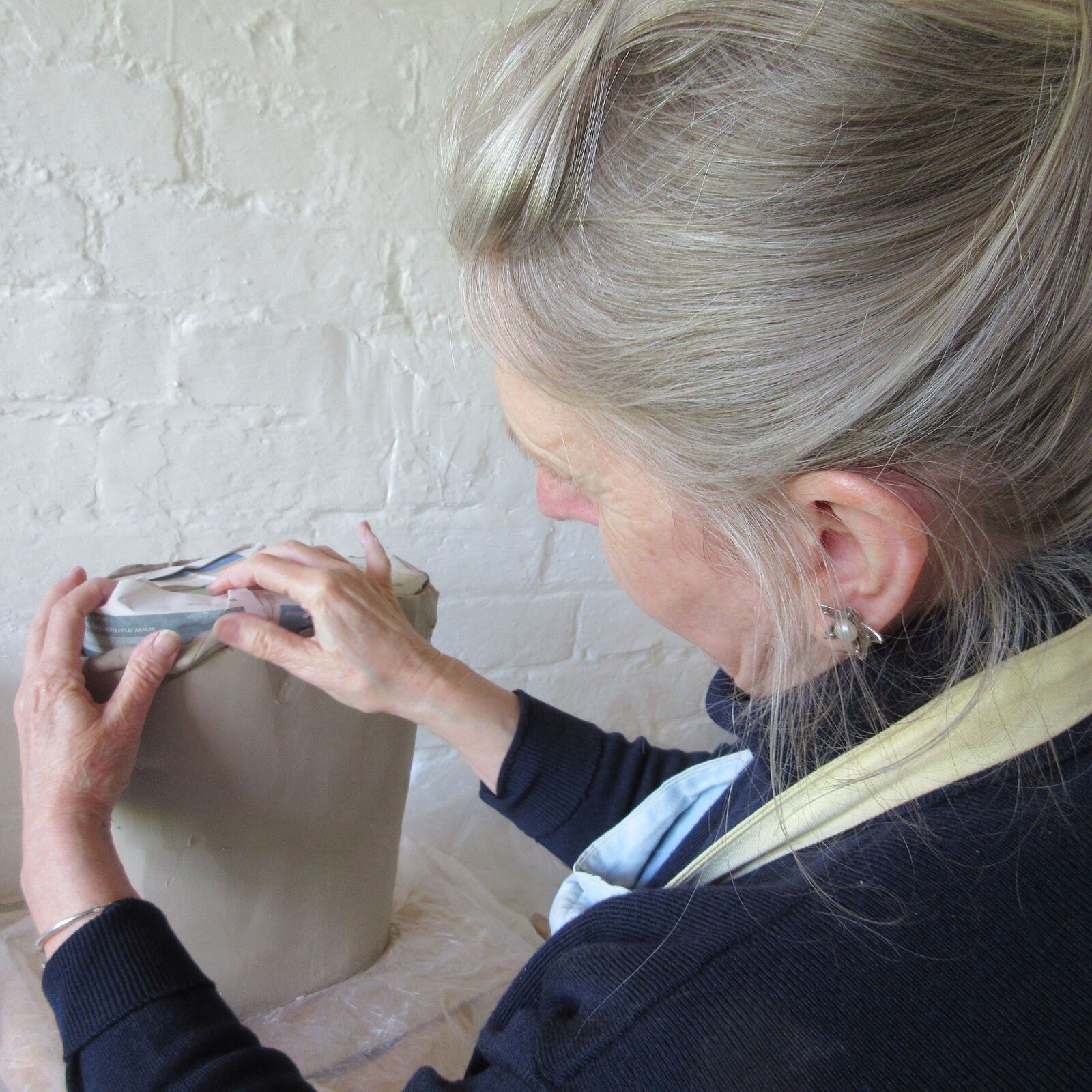 In the studio using the technique of coiling to build the basic form of the vessel in porcelain stoneware.