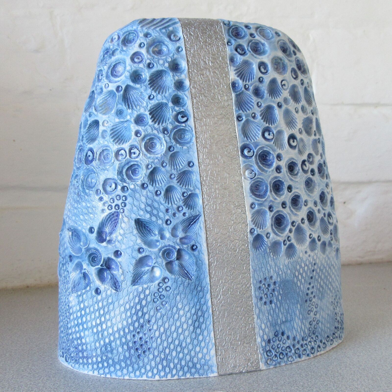 White porcelain stoneware with blue underglaze and transparent glaze, silver strip to finish