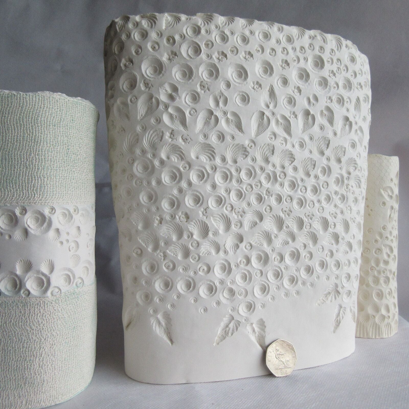 Pure white porcelain stoneware vessel.  Internal sea blue glaze