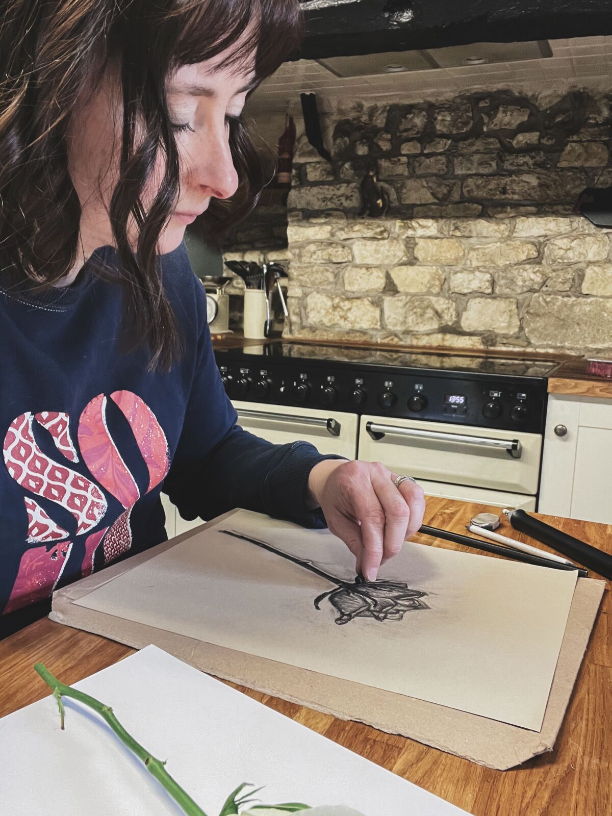 Melody drawing rose using charcoal